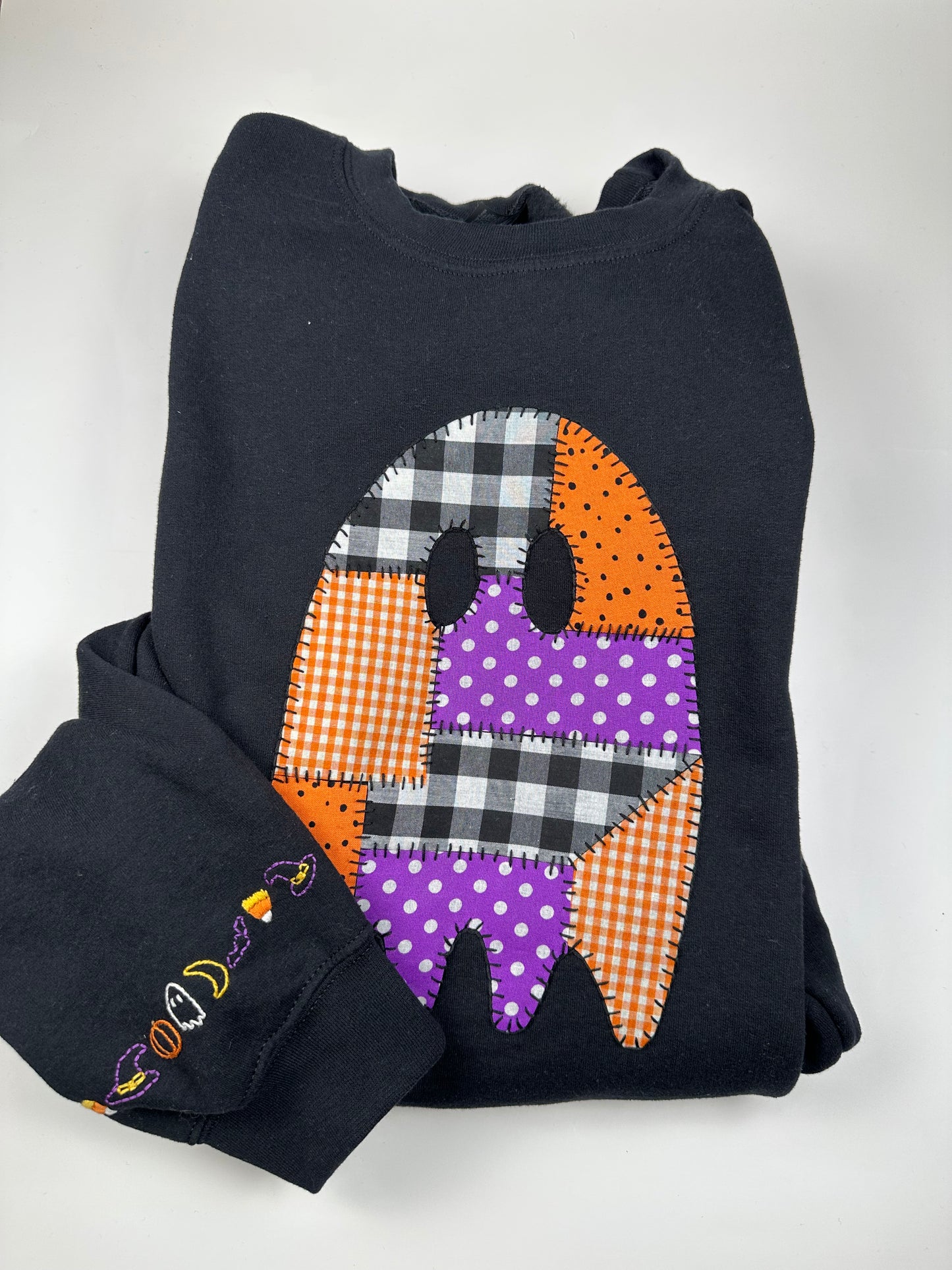 Black sweatshirt with patchwork ghost applique