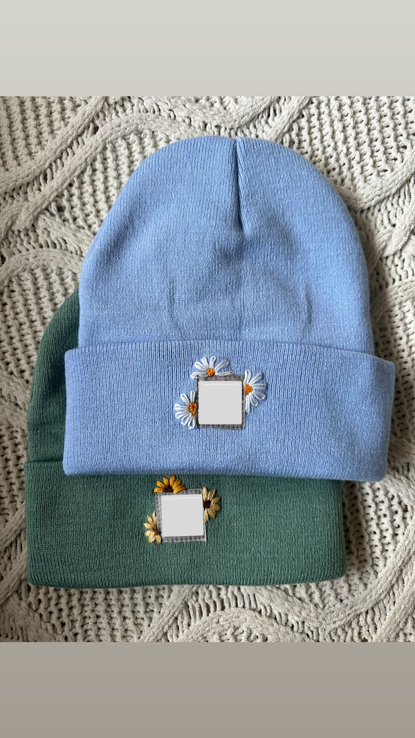 Light blue and green beanies with sunflower embroidery patch and square label