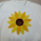 White T-shirt with yellow sunflower applique patch on the chest