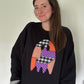 Black crewneck sweatshirt with patchwork applique ghost graphic