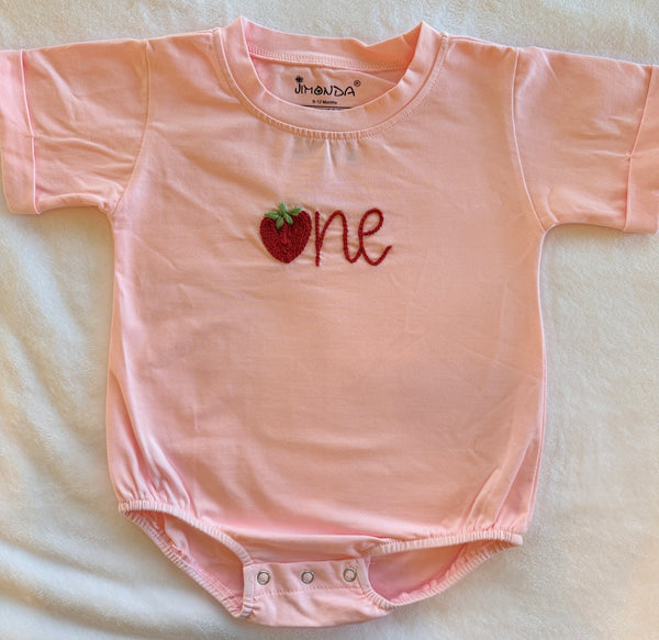 Light pink baby romper with embroidered strawberry 'one' and snap buttons