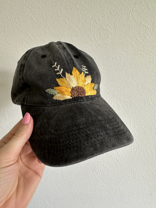 Black embroidered baseball cap with yellow sunflower and multicolor leaf stitching